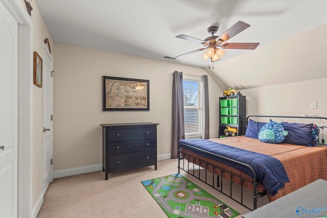 bedroom featuring a ceiling fan, lofted ceiling, light carpet, and baseboards