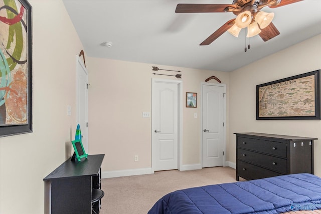 bedroom with ceiling fan, baseboards, and light colored carpet