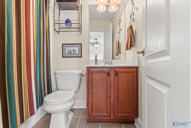 bathroom featuring toilet, a ceiling fan, baseboards, vanity, and tile patterned floors