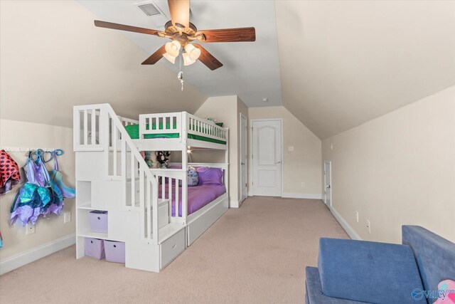 carpeted bedroom with lofted ceiling, visible vents, and baseboards