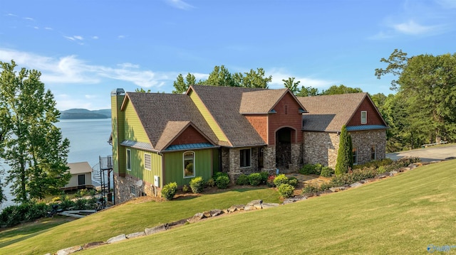 900 Menominee Rd, Langston, AL 35755 - view of front of home featuring a front yard, stone siding, board and batten siding, a chimney, and a water view