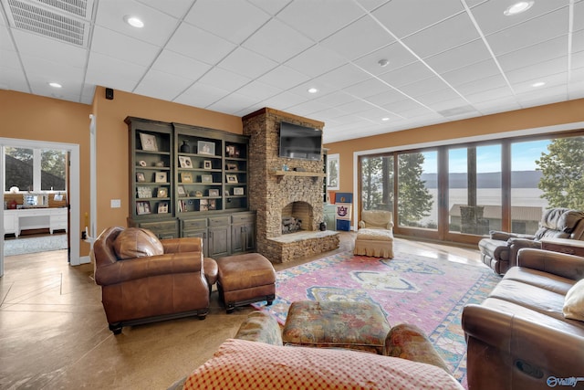 900 Menominee Rd, Langston, AL 35755 - living room with plenty of natural light, a stone fireplace, a drop ceiling, and recessed lighting