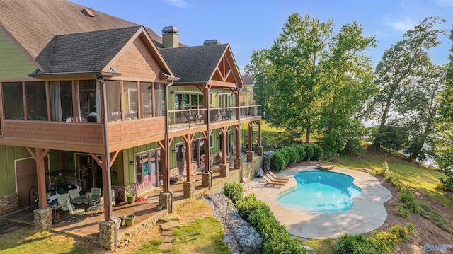 900 Menominee Rd, Langston, AL 35755 - rear view of house featuring a sunroom, a patio area, a chimney, a shingled roof, and an outdoor pool