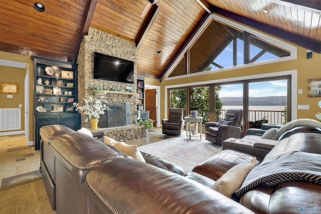 900 Menominee Rd, Langston, AL 35755 - living room with a wooden ceiling with exposed beams, a fireplace, stone tile flooring, and high vaulted ceiling