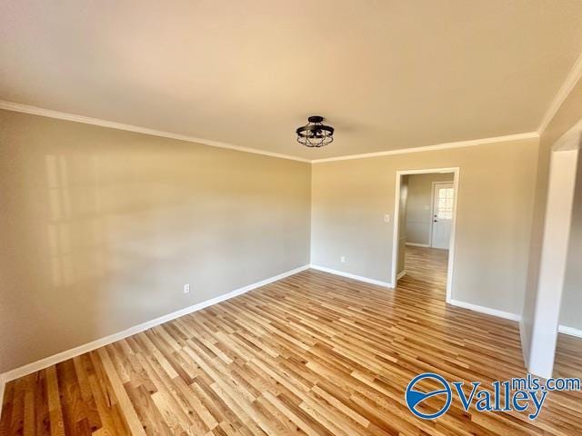 empty room with baseboards and wood finished floors