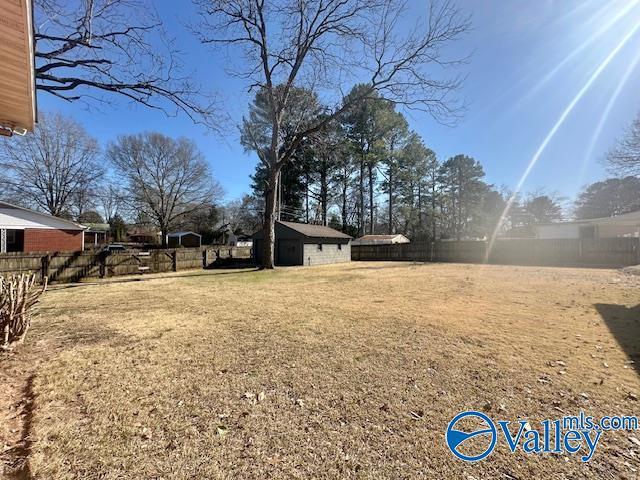 view of yard with an outbuilding and fence