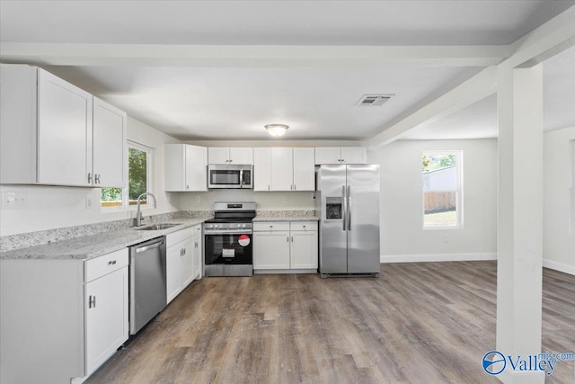 kitchen with white cabinets, stainless steel appliances, and sink