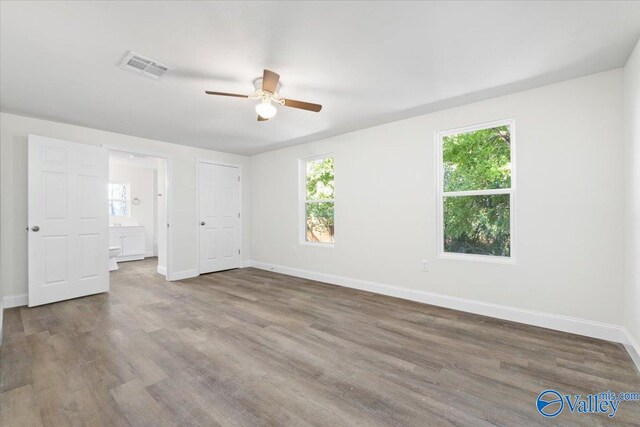 interior space with wood-type flooring and ceiling fan