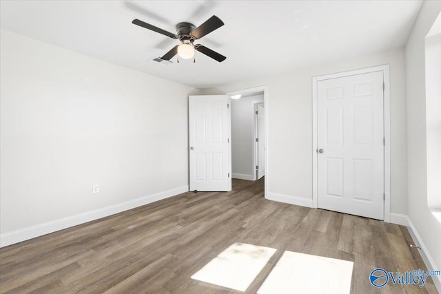 unfurnished bedroom with light wood-type flooring and ceiling fan