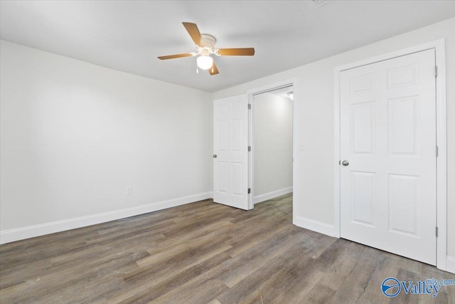 unfurnished bedroom with dark wood-type flooring and ceiling fan