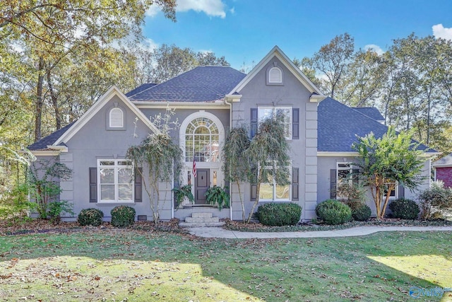 view of property featuring a front lawn