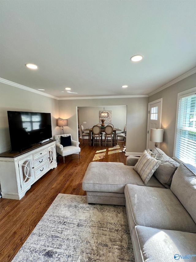 living room with dark wood-type flooring and ornamental molding