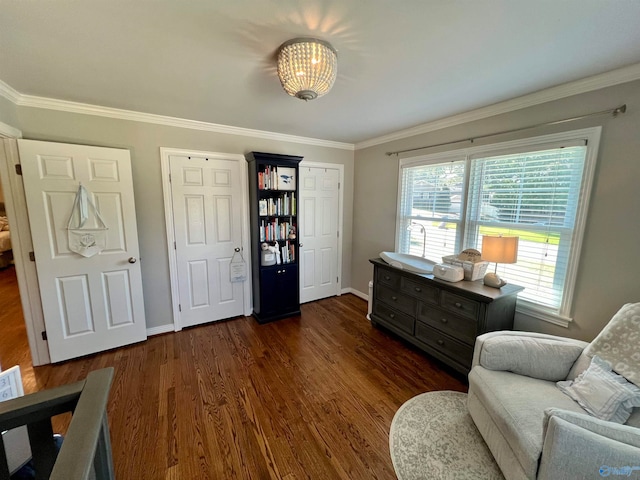 sitting room with crown molding and dark hardwood / wood-style floors