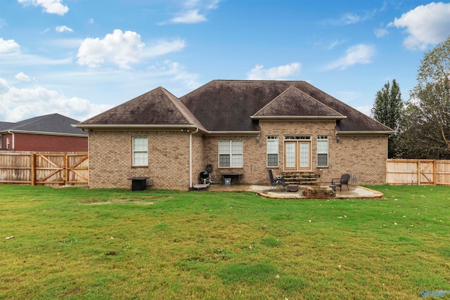 rear view of house featuring a lawn and a patio area