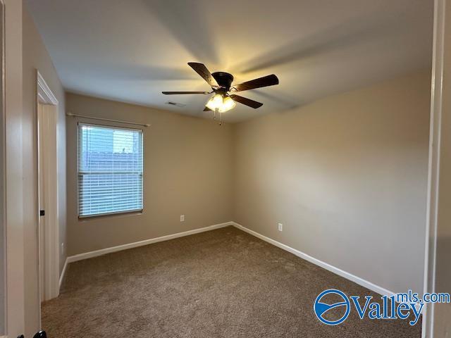 134 Winstead Cir, Owens Cross Roads, AL 35763 - empty room with baseboards, visible vents, ceiling fan, and dark carpet