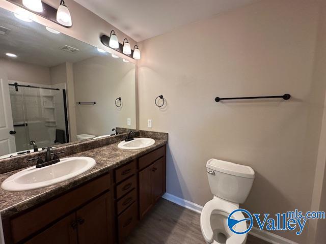 134 Winstead Cir, Owens Cross Roads, AL 35763 - full bathroom featuring a shower stall, toilet, and a sink