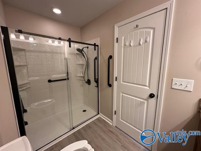 134 Winstead Cir, Owens Cross Roads, AL 35763 - full bathroom with a shower stall, toilet, wood finished floors, and recessed lighting