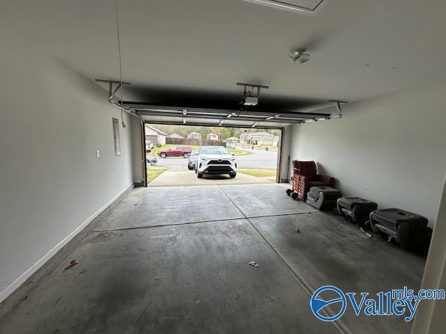 134 Winstead Cir, Owens Cross Roads, AL 35763 - garage featuring a garage door opener and baseboards