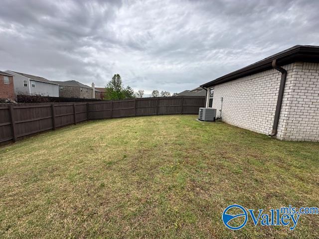 134 Winstead Cir, Owens Cross Roads, AL 35763 - view of yard with a fenced backyard and central AC