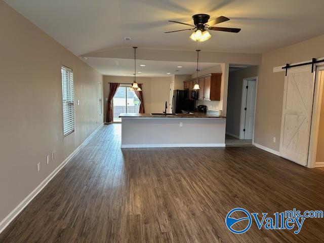 134 Winstead Cir, Owens Cross Roads, AL 35763 - kitchen featuring fridge, baseboards, dark wood finished floors, a barn door, and ceiling fan