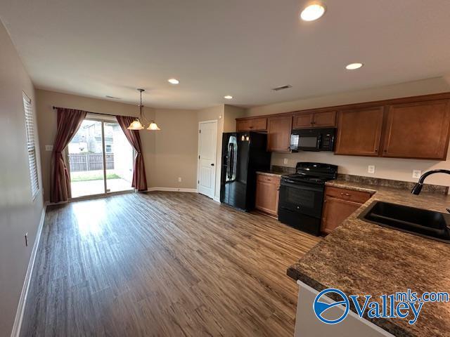 134 Winstead Cir, Owens Cross Roads, AL 35763 - kitchen with wood finished floors, dark countertops, recessed lighting, a sink, and black appliances