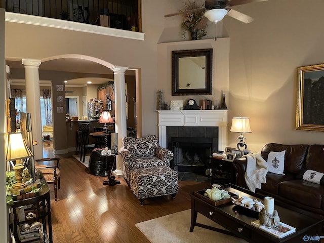 2031 Blake Bottom Rd Unit 2, Huntsville, AL 35806 - living area featuring decorative columns, arched walkways, a ceiling fan, wood finished floors, and a tile fireplace