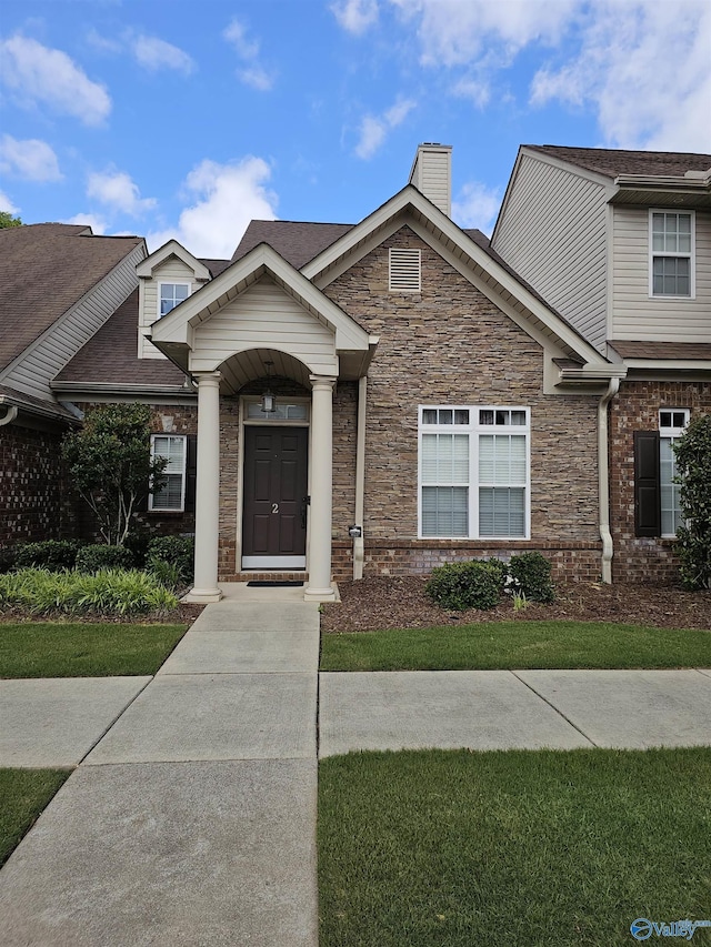 2031 Blake Bottom Rd Unit 2, Huntsville, AL 35806 - view of front of home featuring stone siding, a chimney, and roof with shingles