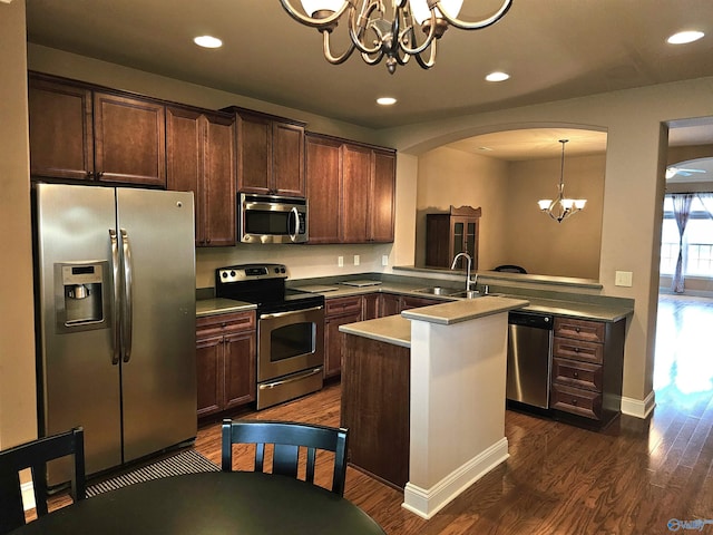 2031 Blake Bottom Rd Unit 2, Huntsville, AL 35806 - kitchen with stainless steel appliances, a chandelier, arched walkways, dark wood finished floors, and dark brown cabinets