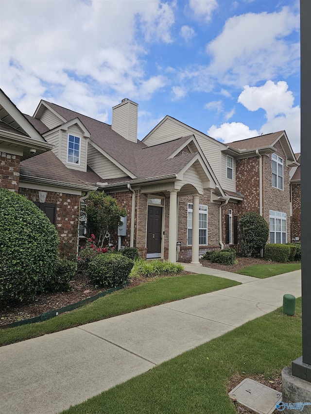 2031 Blake Bottom Rd Unit 2, Huntsville, AL 35806 - view of front of house featuring a chimney, brick siding, roof with shingles, and a front yard