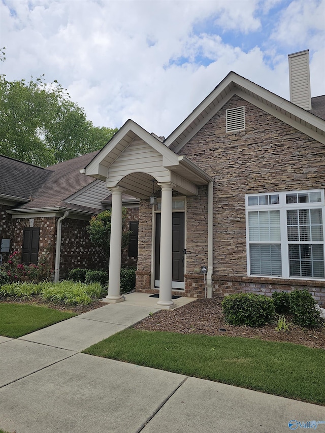 2031 Blake Bottom Rd Unit 2, Huntsville, AL 35806 - view of front of house featuring stone siding, a chimney, and brick siding