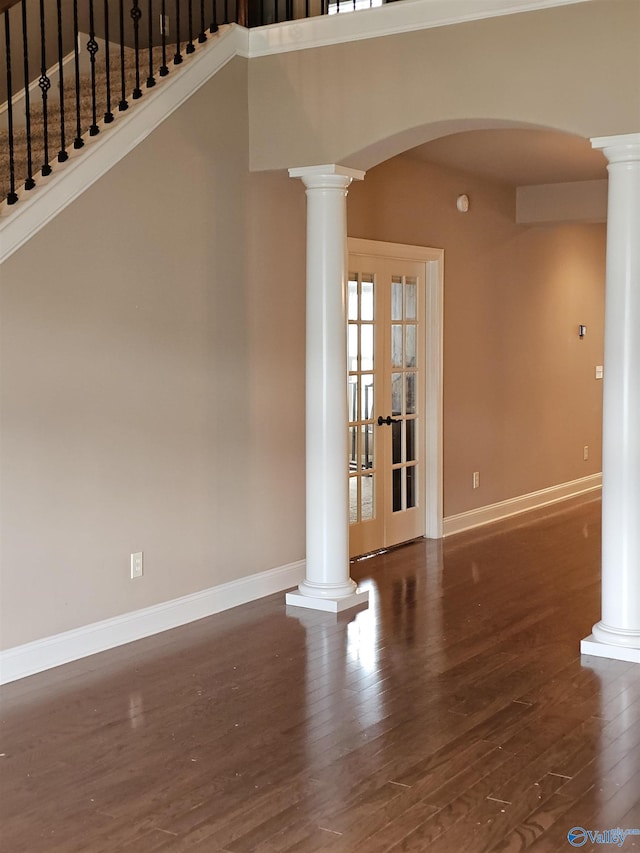 2031 Blake Bottom Rd Unit 2, Huntsville, AL 35806 - unfurnished room featuring ornate columns, wood finished floors, arched walkways, french doors, and stairs