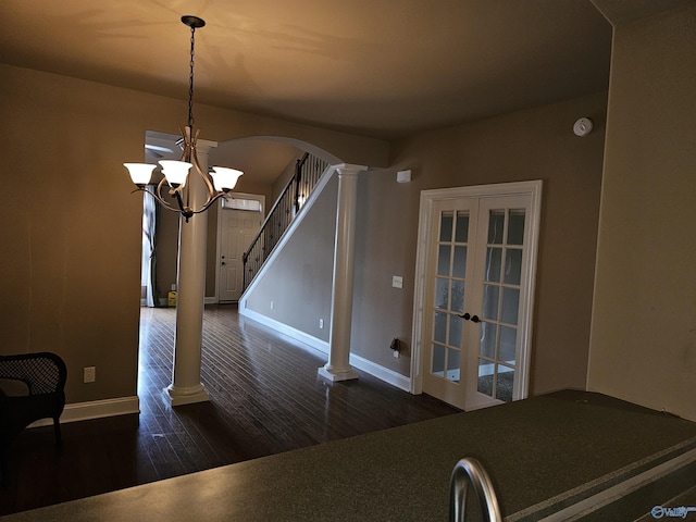 2031 Blake Bottom Rd Unit 2, Huntsville, AL 35806 - unfurnished dining area featuring decorative columns, wood finished floors, french doors, arched walkways, and a chandelier