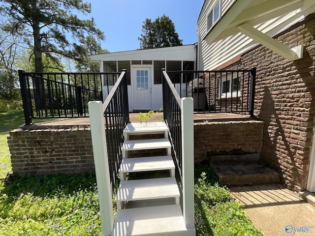 property entrance featuring a wooden deck