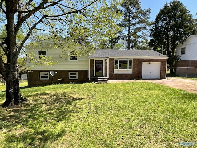 tri-level home featuring entry steps, an attached garage, brick siding, a front lawn, and driveway