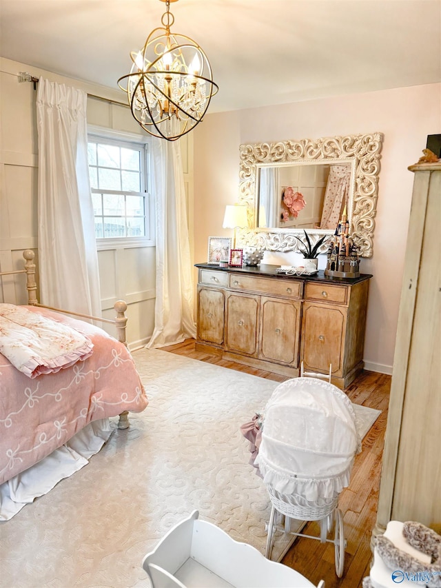 659 Vaughn Bridge Rd NW, Hartselle, AL 35640 - bedroom with a chandelier, baseboards, and light wood-type flooring