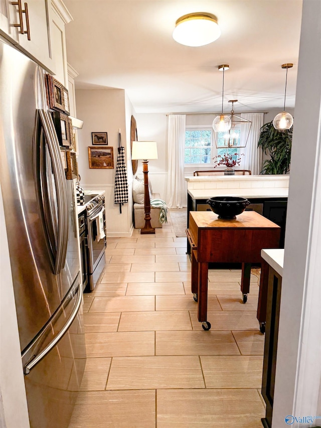 659 Vaughn Bridge Rd NW, Hartselle, AL 35640 - kitchen with appliances with stainless steel finishes, light wood-style flooring, decorative light fixtures, and white cabinets