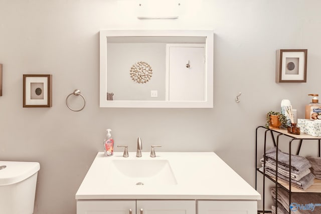 bathroom featuring toilet and vanity