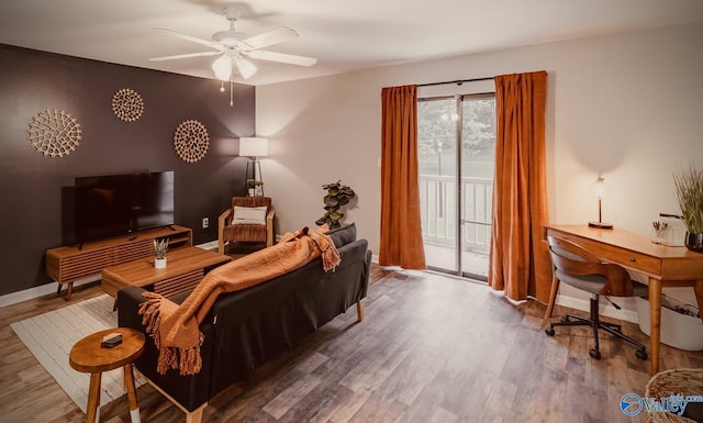 living area with ceiling fan, wood finished floors, and baseboards