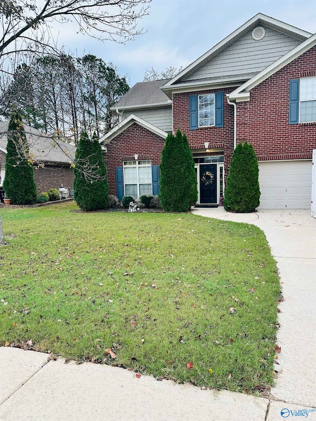 view of front of property with a front yard and a garage