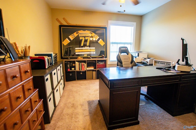 carpeted office space with ceiling fan