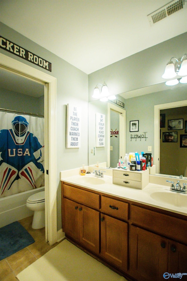 full bathroom with tile patterned floors, shower / tub combo with curtain, vanity, and toilet