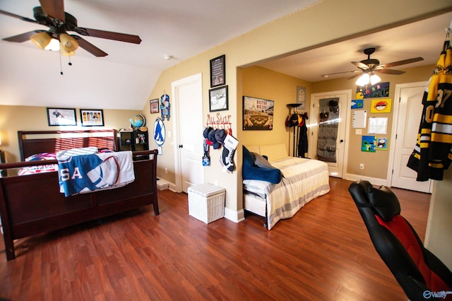 bedroom featuring ceiling fan, dark wood-type flooring, and vaulted ceiling