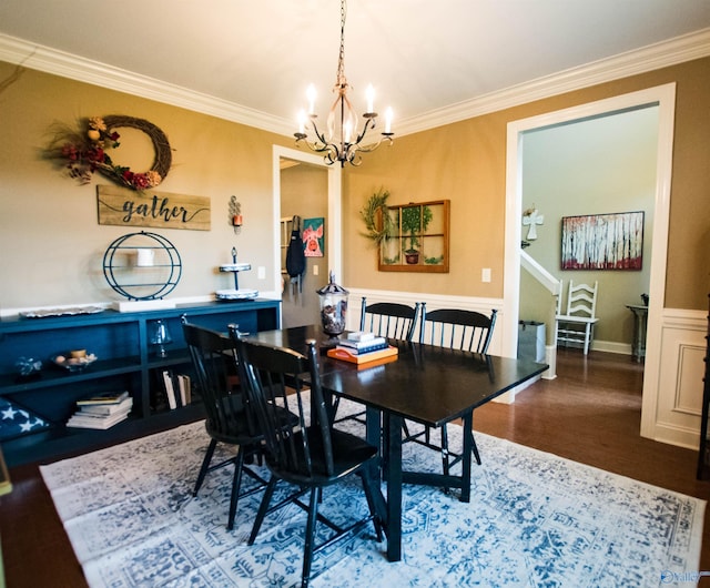 dining area featuring hardwood / wood-style flooring, a notable chandelier, and crown molding