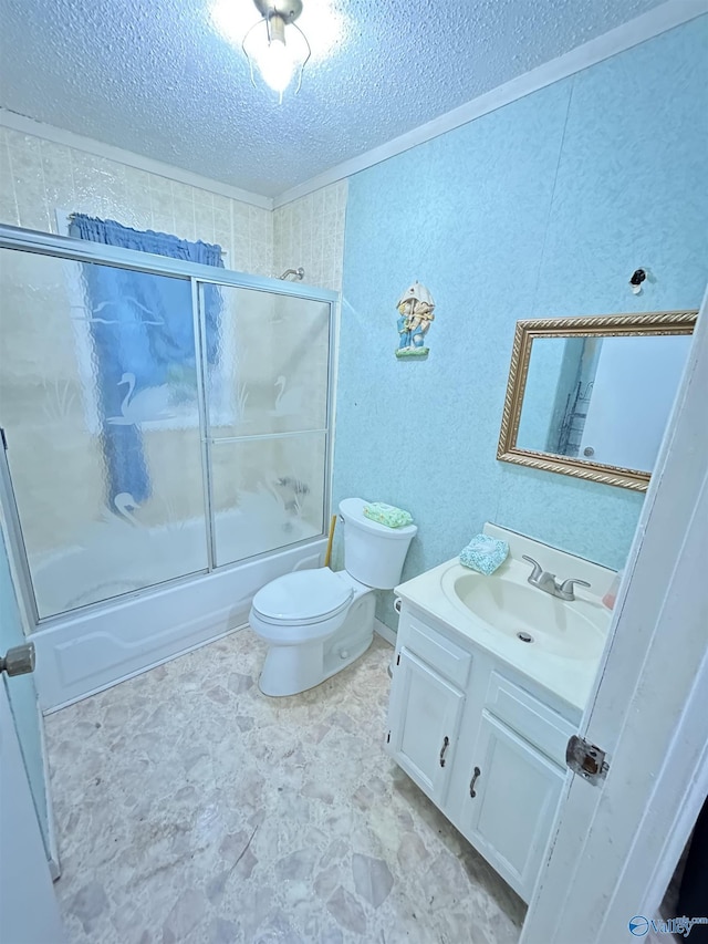 full bathroom with vanity, bath / shower combo with glass door, toilet, and a textured ceiling