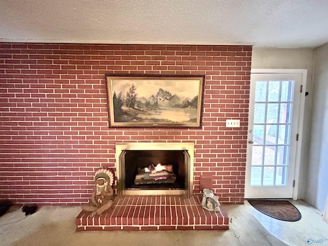 unfurnished living room featuring a brick fireplace and a textured ceiling