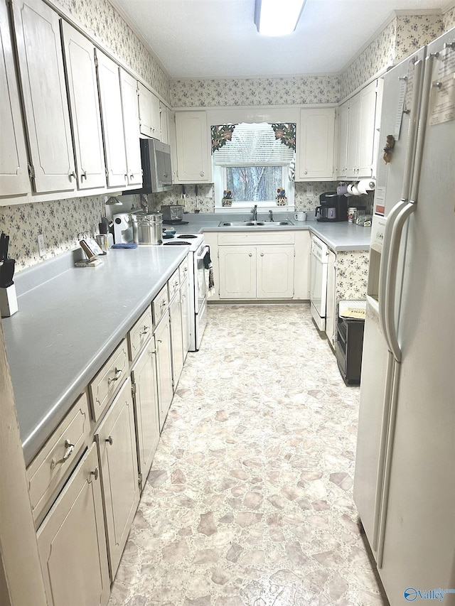 kitchen with sink and white appliances