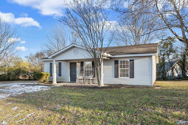 single story home featuring a porch and a front yard