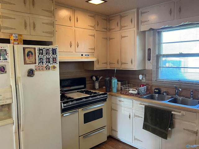 kitchen featuring decorative backsplash, white cabinetry, white appliances, and sink