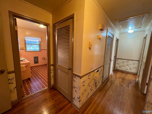 corridor with crown molding and tile patterned floors