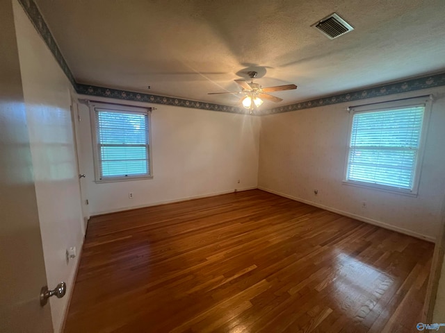 spare room with wood-type flooring, a textured ceiling, and ceiling fan